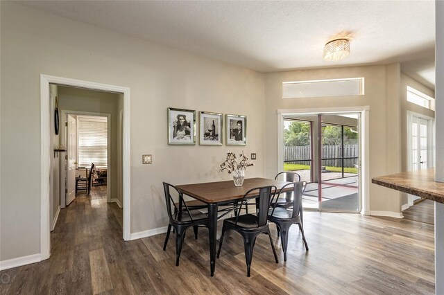 dining area featuring wood finished floors and baseboards