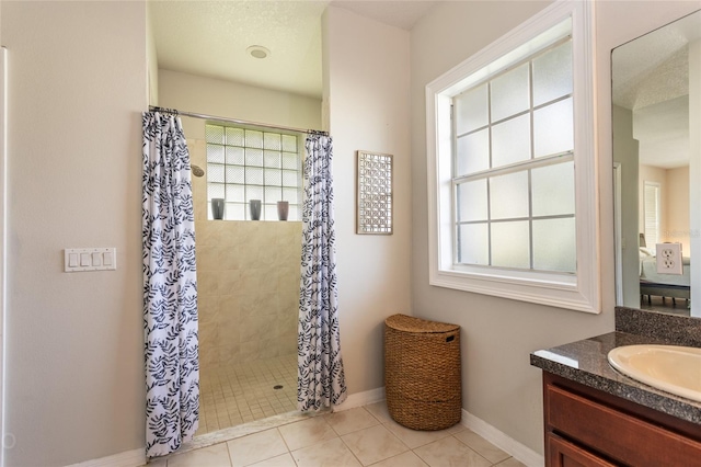 bathroom featuring tile patterned flooring, vanity, curtained shower, and plenty of natural light