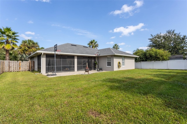 rear view of property featuring a sunroom, a patio, and a yard