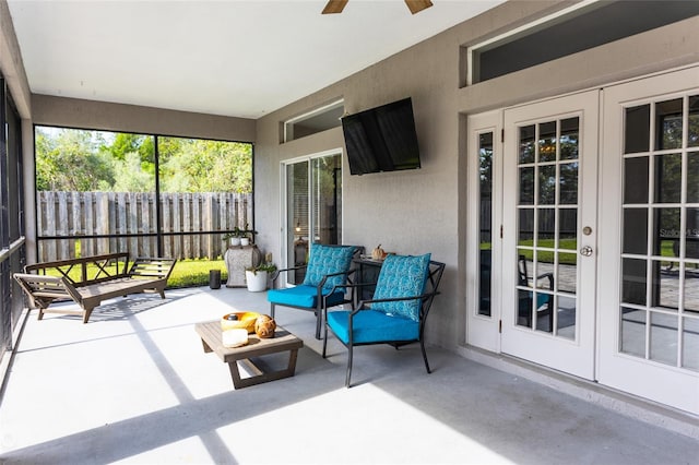 sunroom with a ceiling fan and french doors