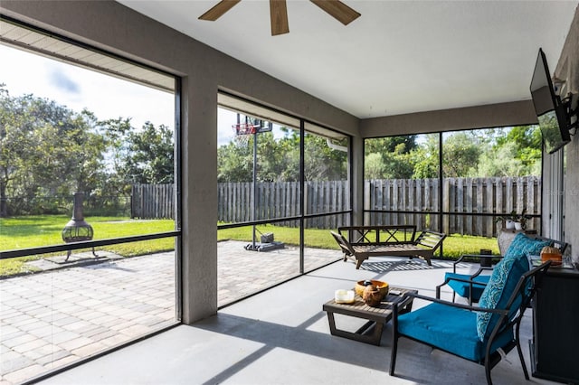 sunroom / solarium featuring ceiling fan