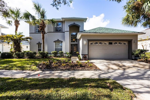 view of front of house featuring a front yard and a garage