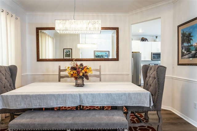30 Front St, Palm Coast, FL 32137 - dining space featuring dark wood-style flooring, a chandelier, baseboards, and ornamental molding