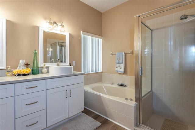 bathroom with vanity, separate shower and tub, and hardwood / wood-style floors