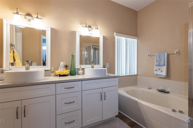 bathroom featuring vanity and separate shower and tub