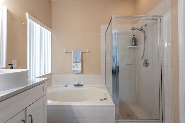 bathroom with vanity and independent shower and bath