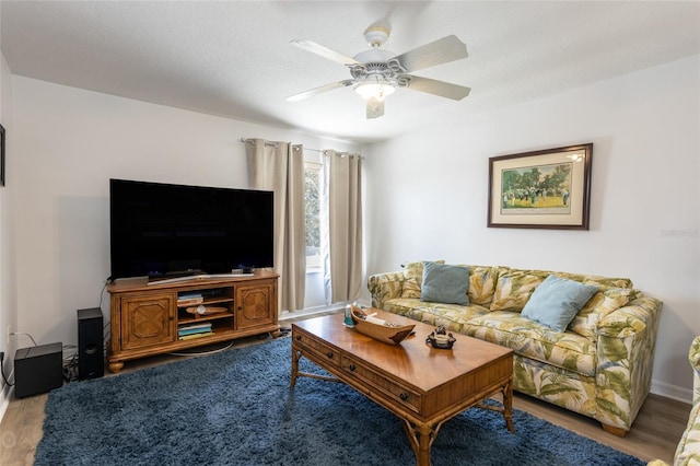 living room with hardwood / wood-style flooring and ceiling fan