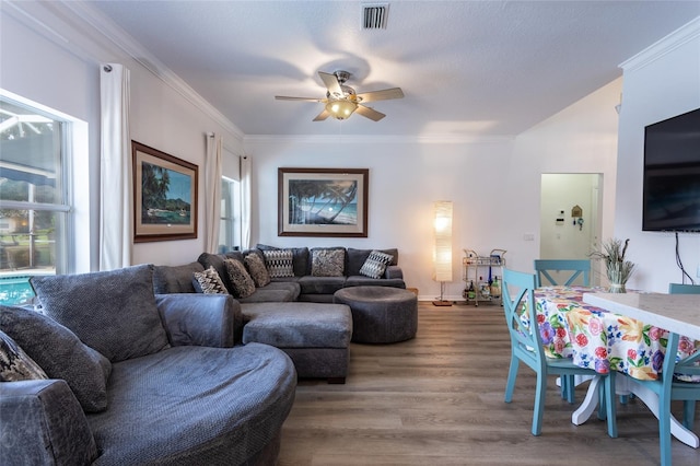 living room featuring ornamental molding, hardwood / wood-style floors, and ceiling fan