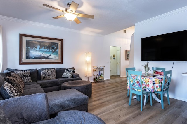 living room featuring crown molding, dark hardwood / wood-style floors, and ceiling fan