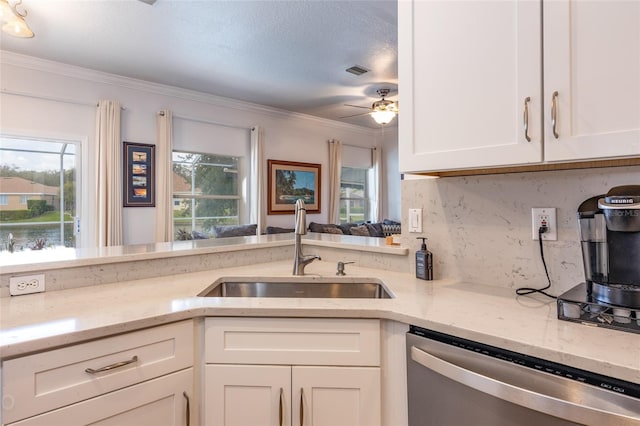 kitchen featuring light stone countertops, sink, stainless steel dishwasher, and white cabinets