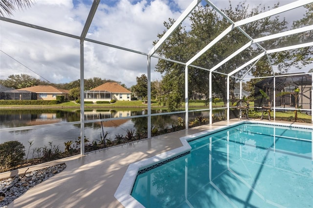 view of pool with a patio, a water view, and glass enclosure