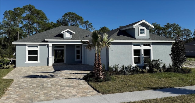 view of front of house with a front yard and a garage