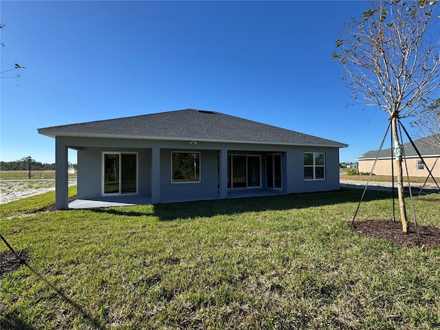 back of property featuring a yard and a patio area