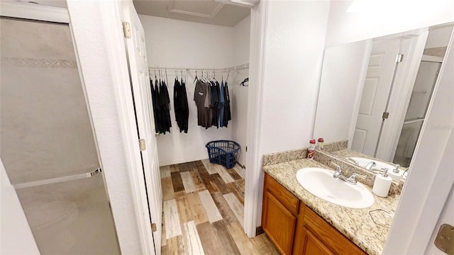 bathroom featuring vanity, hardwood / wood-style floors, and an enclosed shower