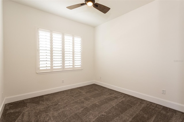 unfurnished room with dark colored carpet and ceiling fan