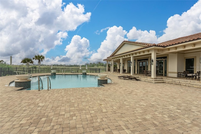 view of pool with a patio area and a jacuzzi