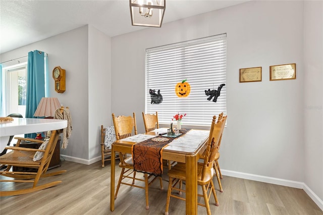 dining room featuring a notable chandelier and light hardwood / wood-style flooring