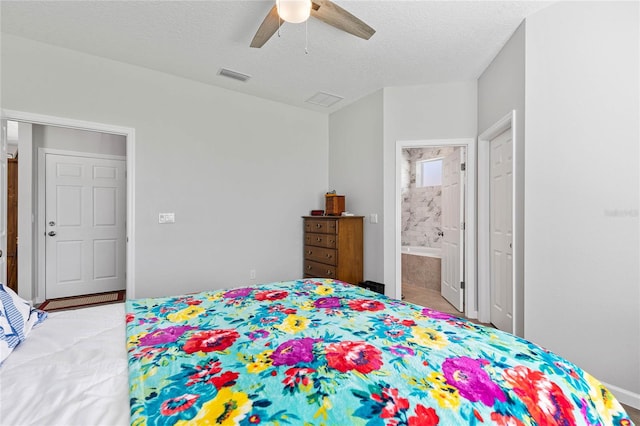 bedroom featuring ceiling fan, a textured ceiling, and connected bathroom