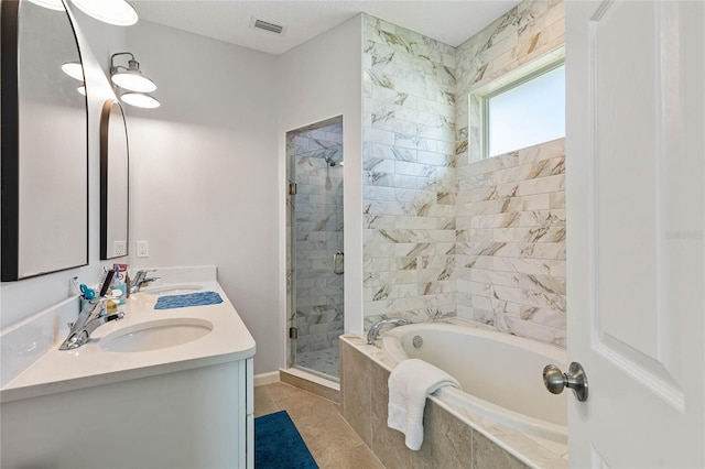 bathroom featuring vanity, shower with separate bathtub, and tile patterned flooring