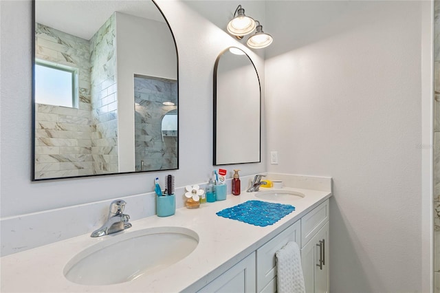 bathroom with vanity and tiled shower