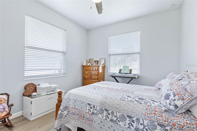 bedroom with light hardwood / wood-style floors, multiple windows, and ceiling fan