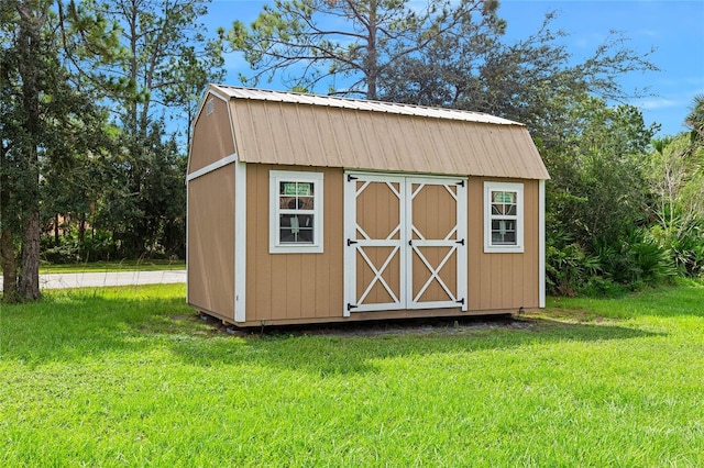 view of outbuilding featuring a yard