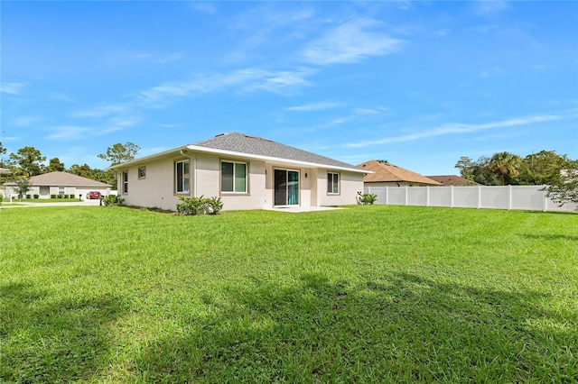 rear view of house with a yard