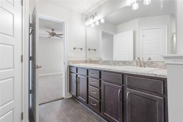 bathroom with wood-type flooring, vanity, and ceiling fan