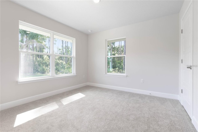 spare room featuring light colored carpet