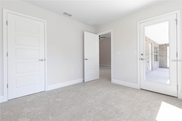 unfurnished room with light carpet