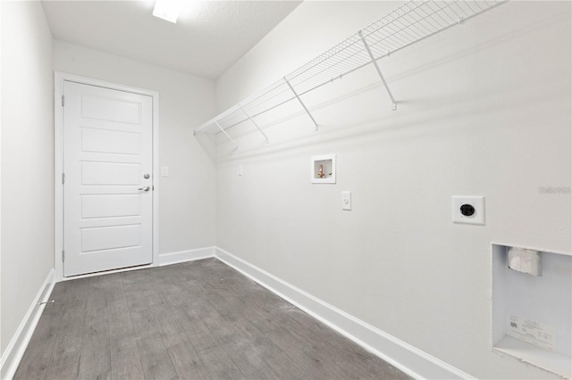 washroom with hookup for an electric dryer, hardwood / wood-style floors, and washer hookup