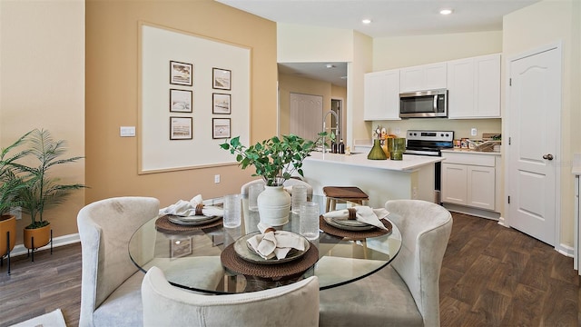 dining space featuring lofted ceiling and dark hardwood / wood-style flooring