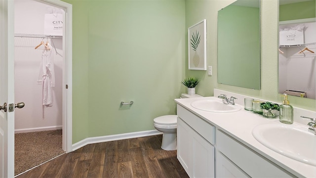 bathroom featuring hardwood / wood-style flooring, vanity, and toilet