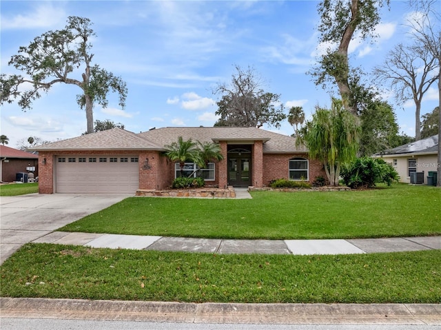 ranch-style house featuring a garage and a front lawn