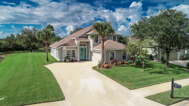 12 S Lakewalk Dr, Palm Coast, FL 32137 - view of front of house featuring concrete driveway, stucco siding, a front lawn, and a garage