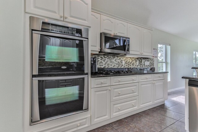 12 S Lakewalk Dr, Palm Coast, FL 32137 - kitchen featuring stainless steel appliances, backsplash, white cabinets, and tile patterned flooring