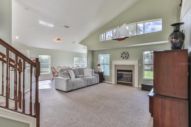 12 S Lakewalk Dr, Palm Coast, FL 32137 - living room with high vaulted ceiling, stairway, carpet flooring, a fireplace, and baseboards