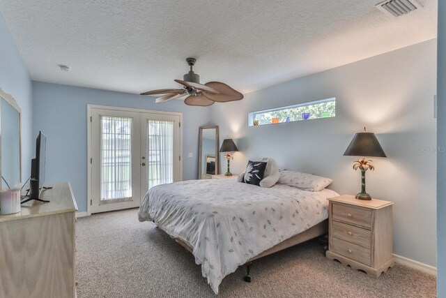 bedroom featuring ceiling fan, french doors, light carpet, access to outside, and a textured ceiling