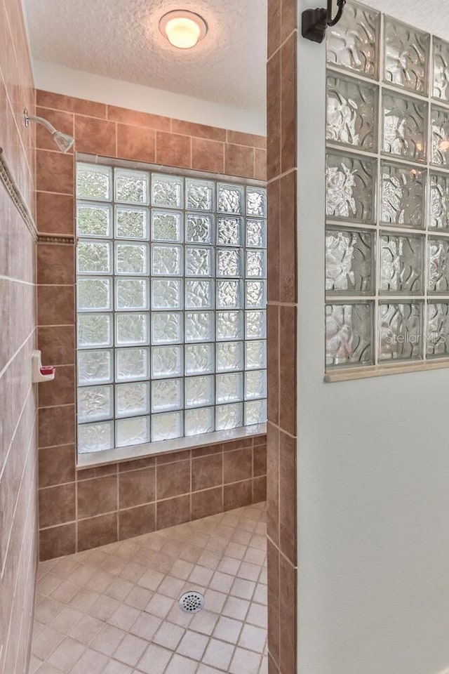 bathroom featuring a shower and a textured ceiling