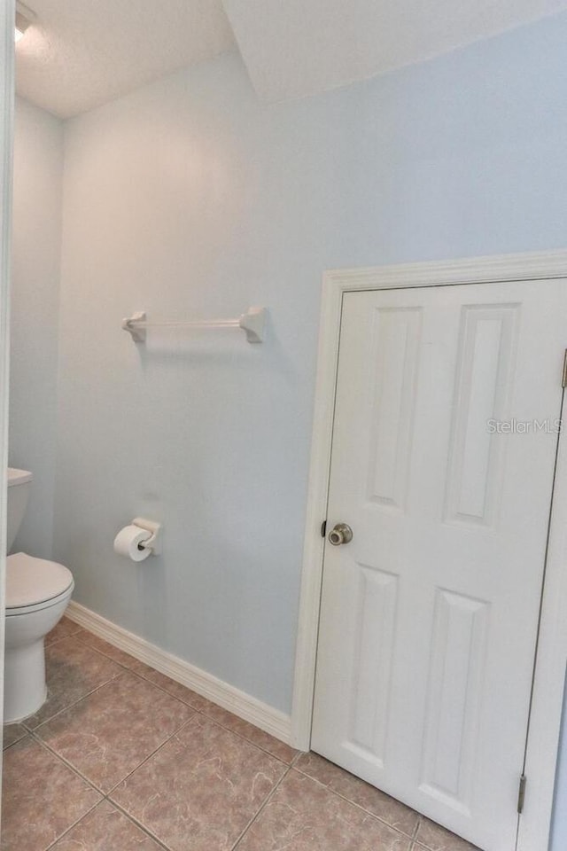 bathroom featuring tile patterned flooring and toilet