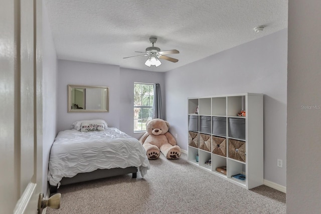 12 S Lakewalk Dr, Palm Coast, FL 32137 - carpeted bedroom featuring a ceiling fan, a textured ceiling, and baseboards