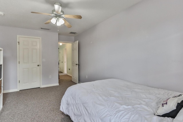 bedroom with carpet floors, a textured ceiling, and ceiling fan