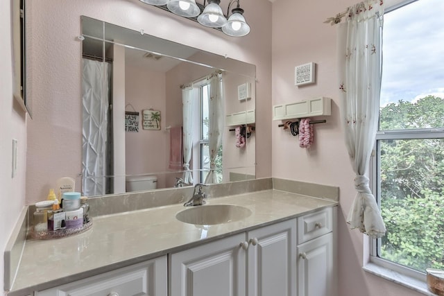 12 S Lakewalk Dr, Palm Coast, FL 32137 - bathroom with vanity, toilet, and a shower with shower curtain