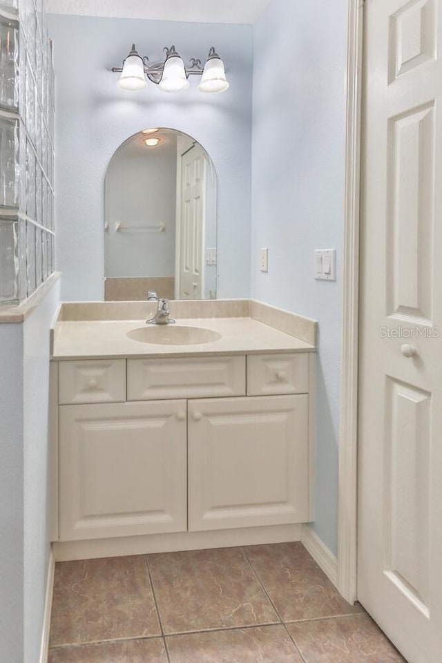 12 S Lakewalk Dr, Palm Coast, FL 32137 - bathroom with vanity, tile patterned flooring, and baseboards