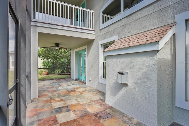 view of patio / terrace with ceiling fan and a balcony