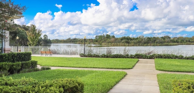 exterior space with a water view and a lawn