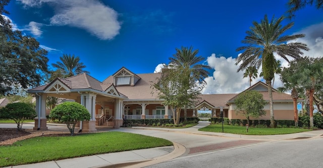 12 S Lakewalk Dr, Palm Coast, FL 32137 - view of front facade featuring a front lawn, a tile roof, and stucco siding