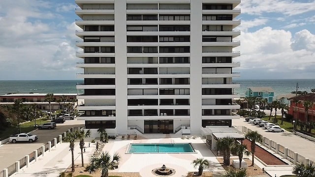 view of property with a water view and a community pool