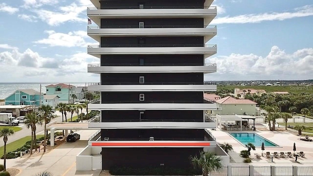 view of building exterior with a community pool