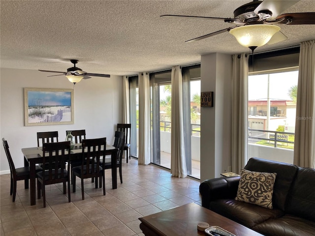 dining space featuring ceiling fan, a textured ceiling, and light tile patterned floors